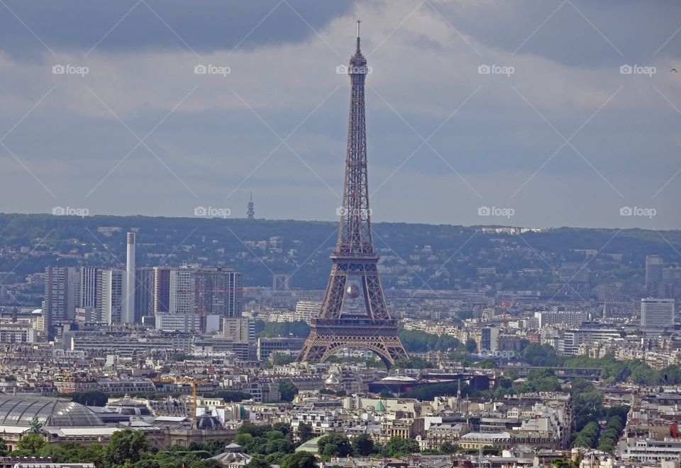 Eiffel tower against cloudy sky