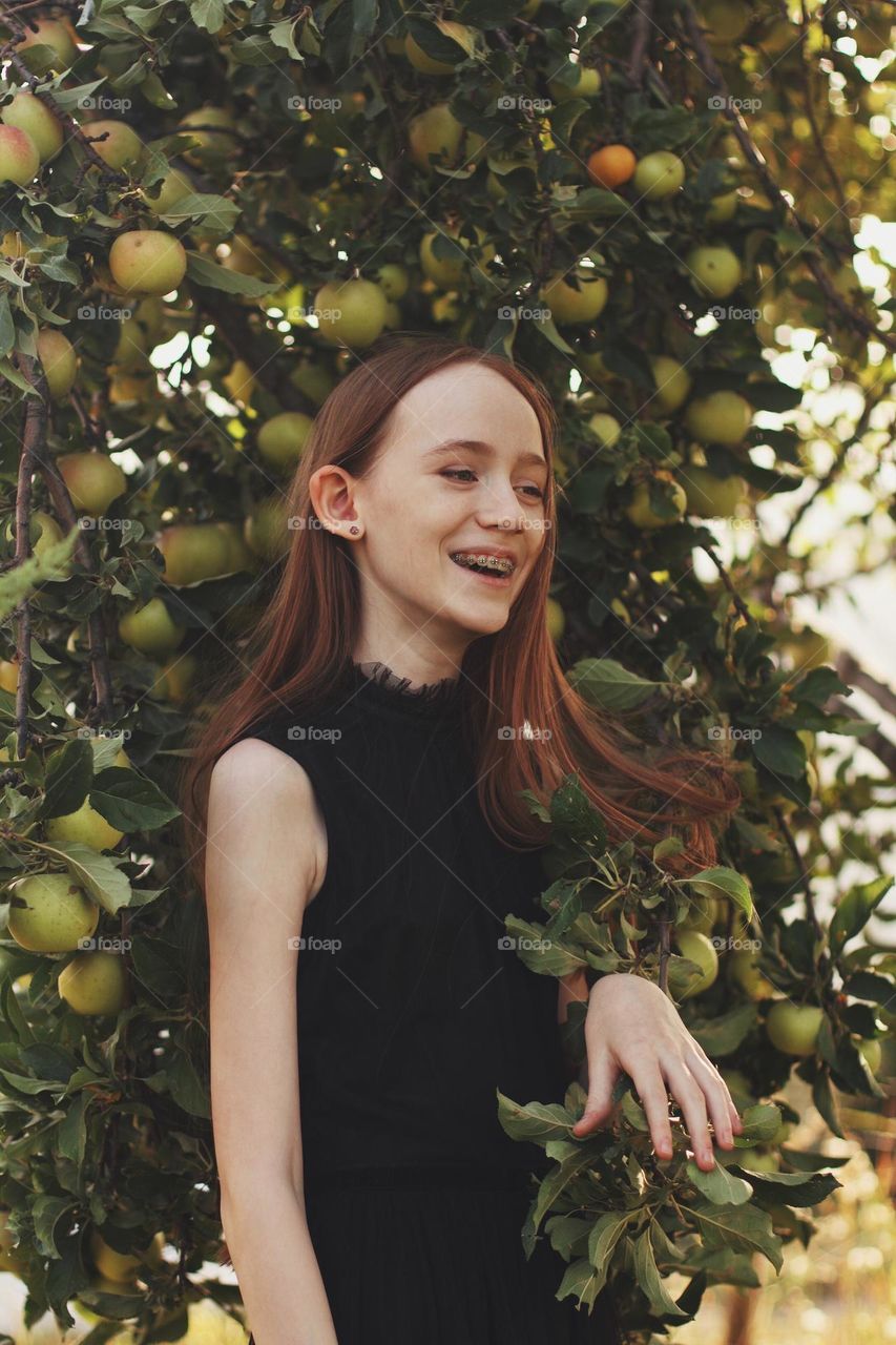 Girl laughing at apples