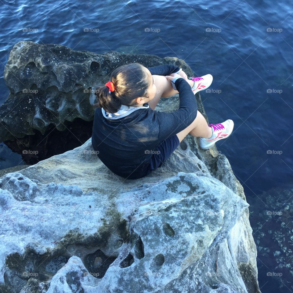 Girl sitting on rocks