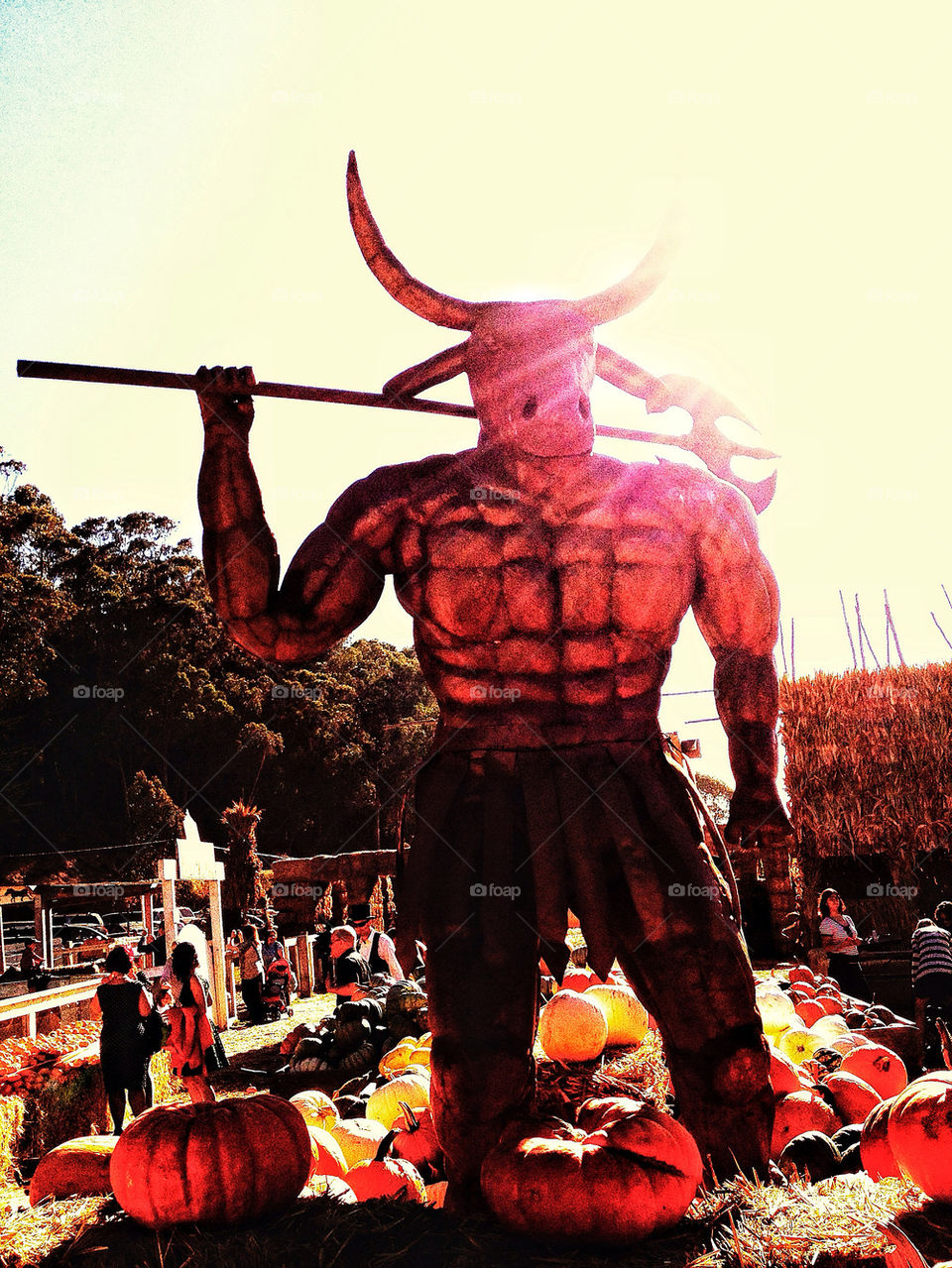 Imposing rusty iron statue of Minotaur in a Halloween harvest farm