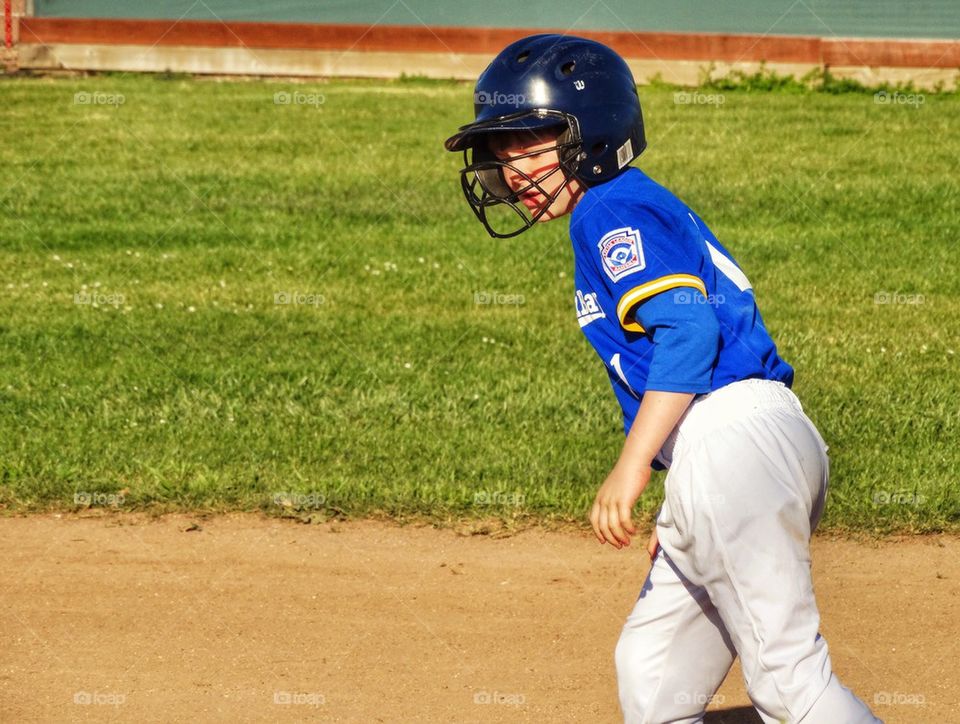 Little League Player Leading Off Base
