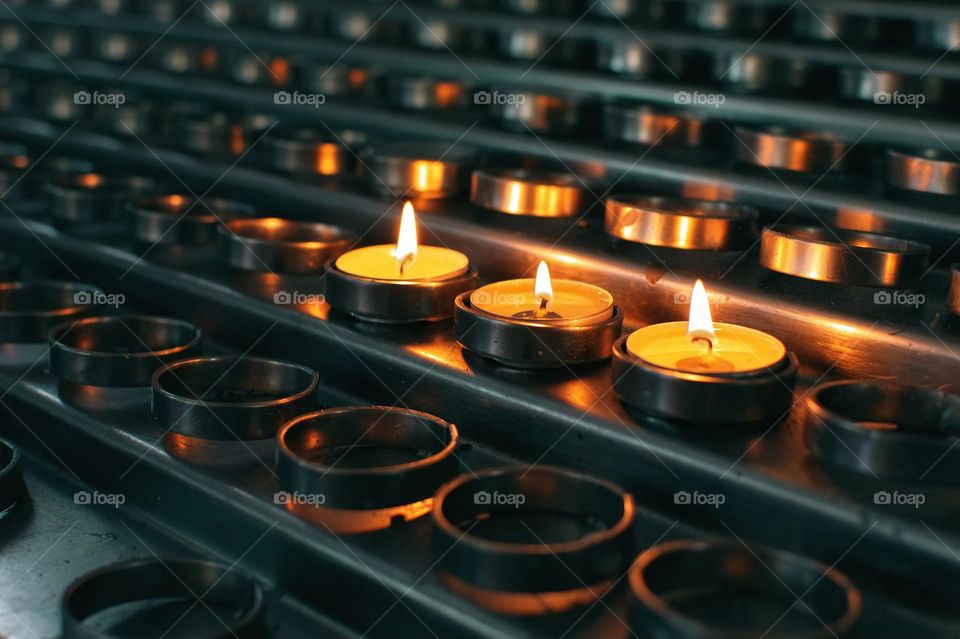 Metal candle holders with three burning candles