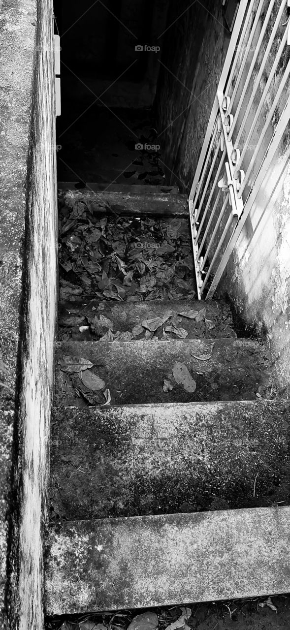down the stairs towards the dark