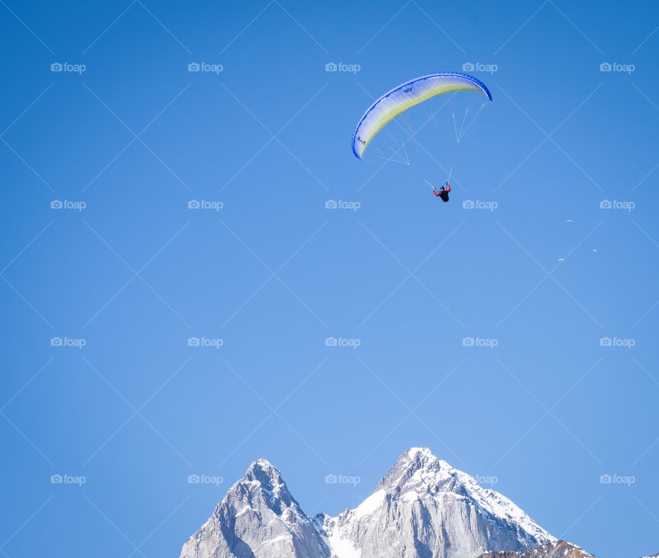 Parachute on the beautiful blue sky over Caucasus Mountains in Georgia, new landmark for tourists around the world 