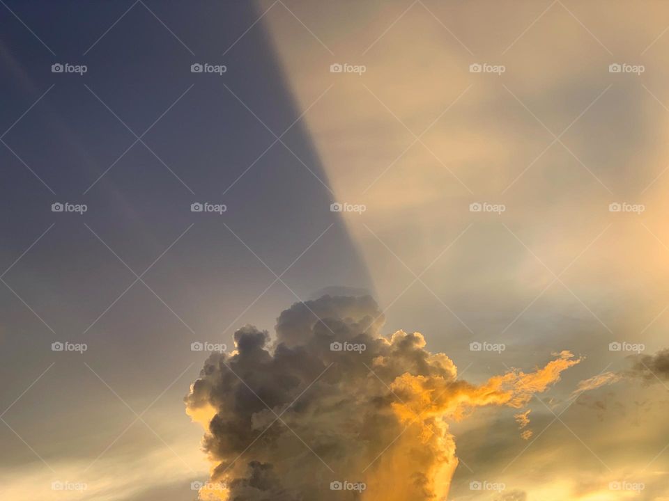 Sunbeams shining through a beautiful sunset cloudscape.