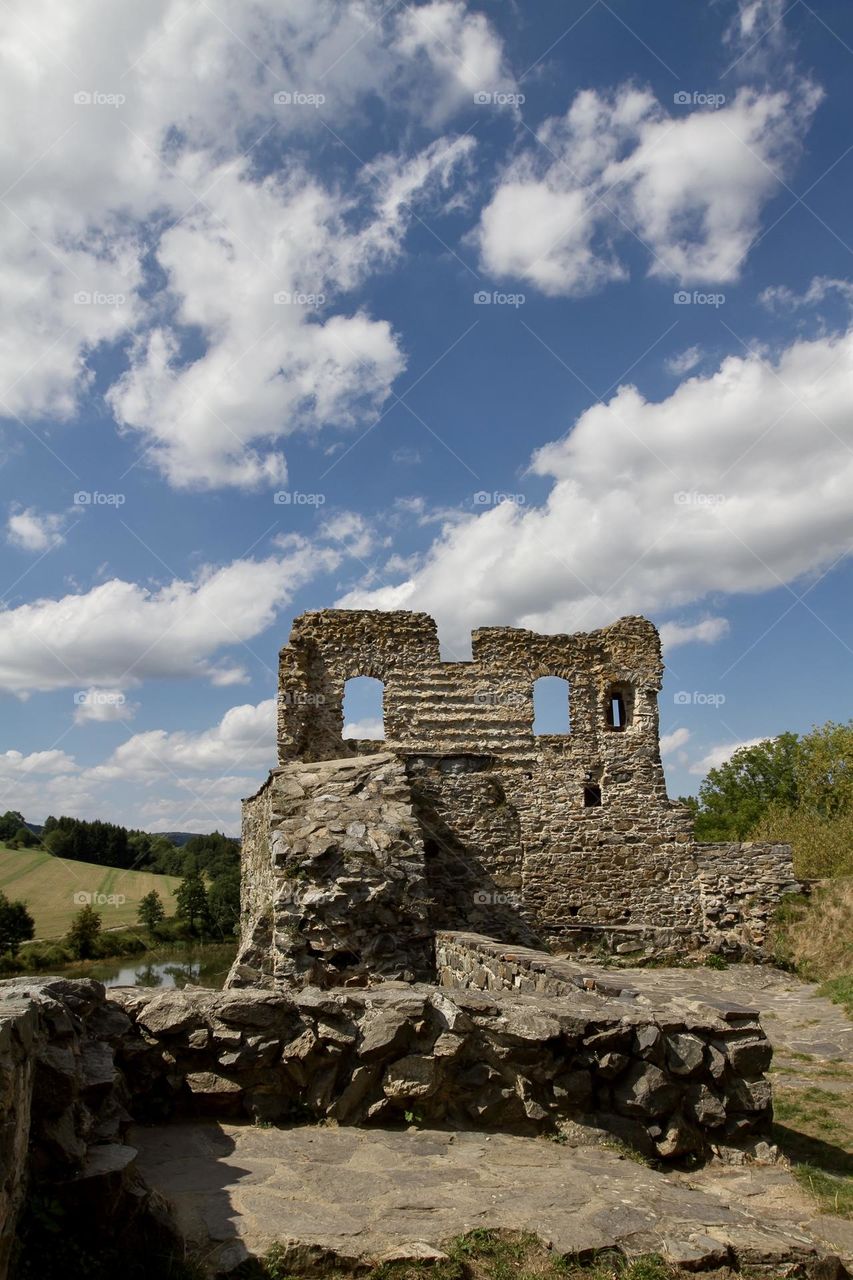 Borotin Castle ruins and blue sky with clouds in Borotin, South Bohemia, Czech Republic. 