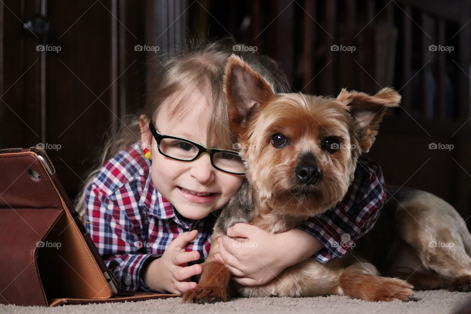 Child cuddling their best friend