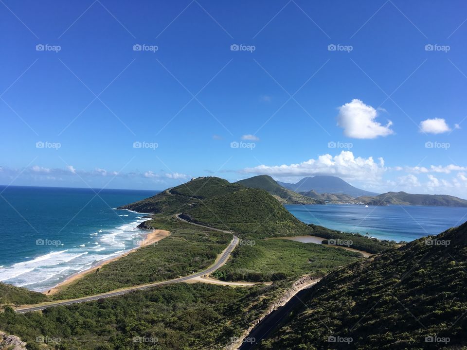 Atlantic and pacific meet In st. kitts, clear skies and a sunny day in the Caribbean, empty roads and lush vegetation 