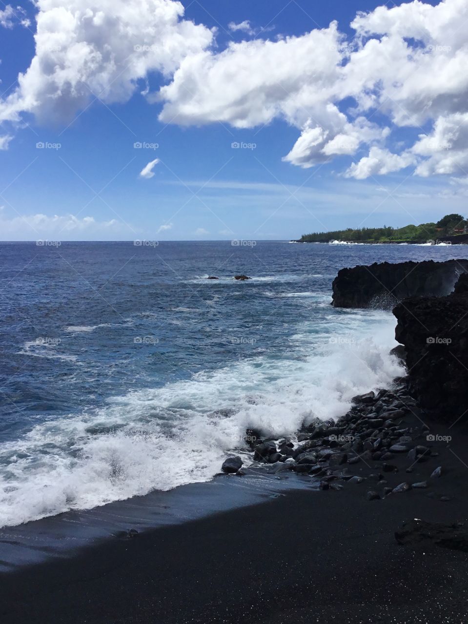 Black beach and white clouds