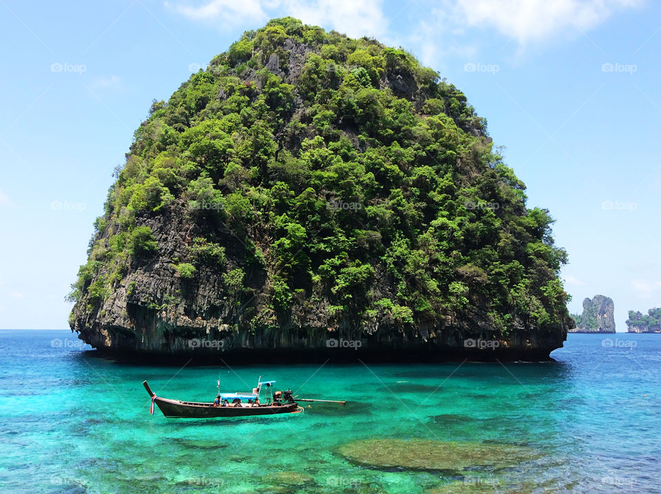 Enjoying the last summer days swimming in boat along the tropical island 