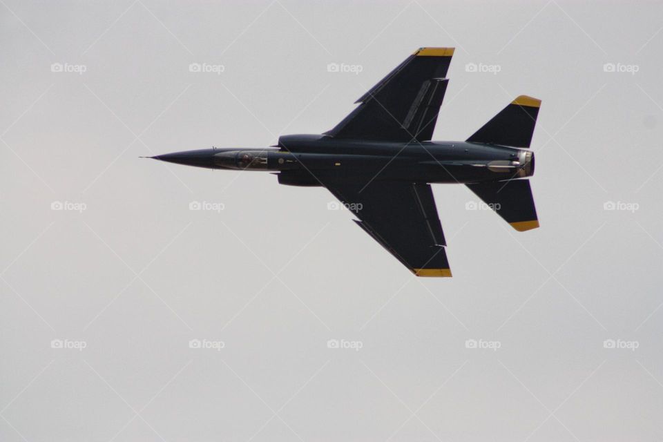 a Mirage fighter jet doing a flyby. triangular shape of the wings.