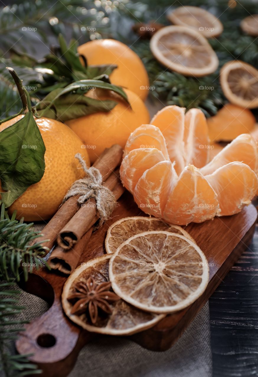 Flatlay mandarin orange cinnamon and Christmas tree branches 