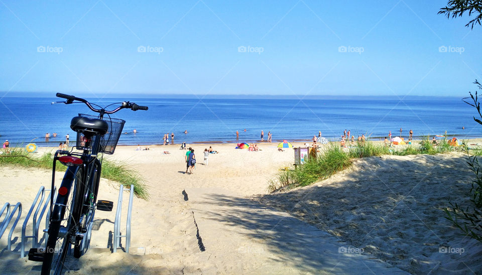 Bike on the beach on a background of blue sea