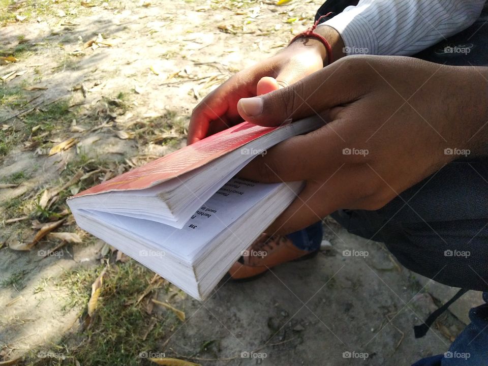 student hold book