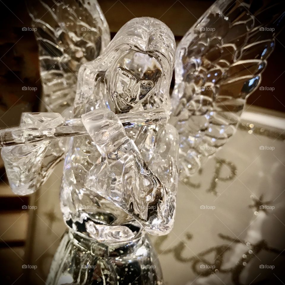 Glass statue angel playing the flute 