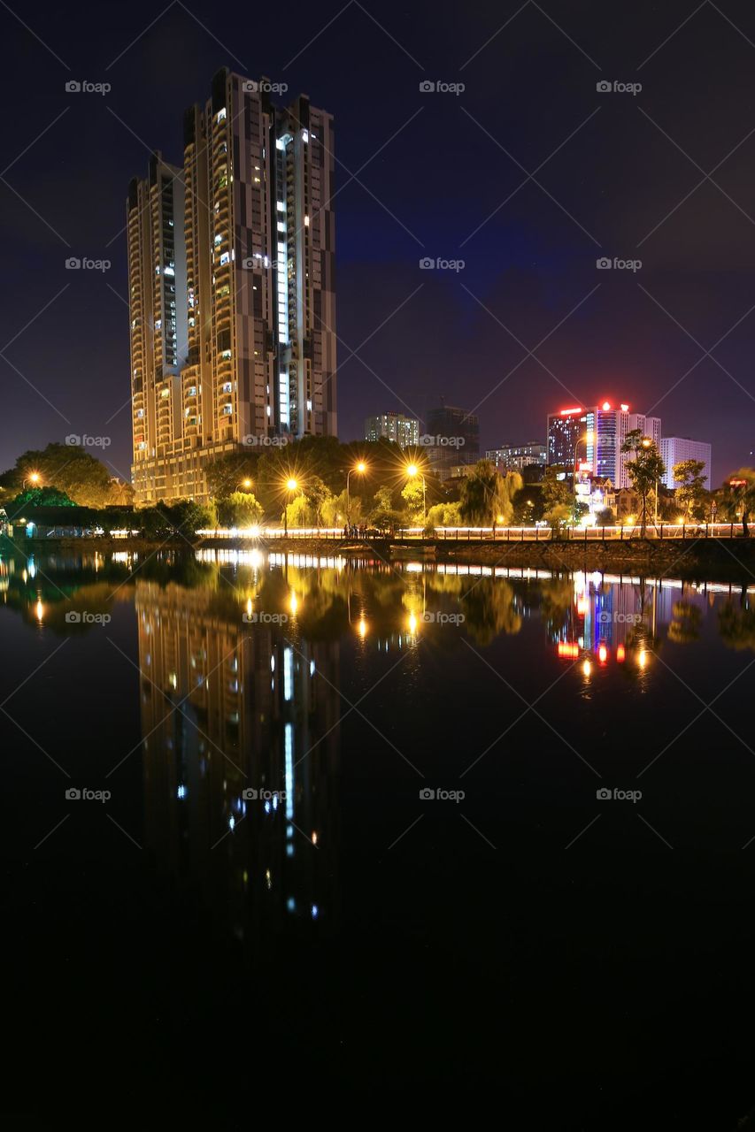 Van Quan lake by night with longexposure,  reflection of Skyline tower