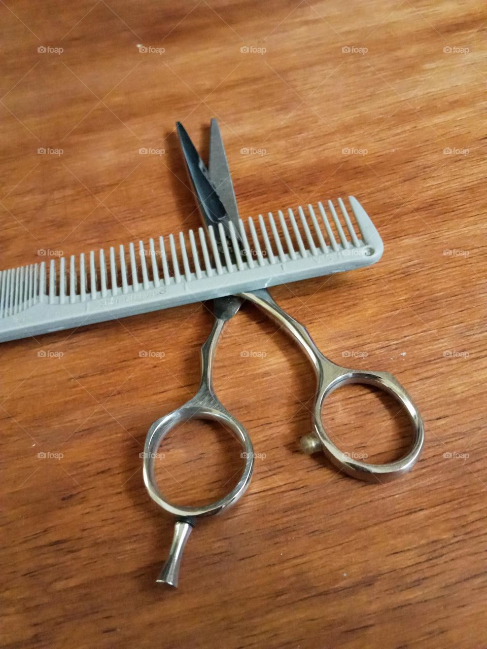 Cutting tools, comb and scissor on the table.