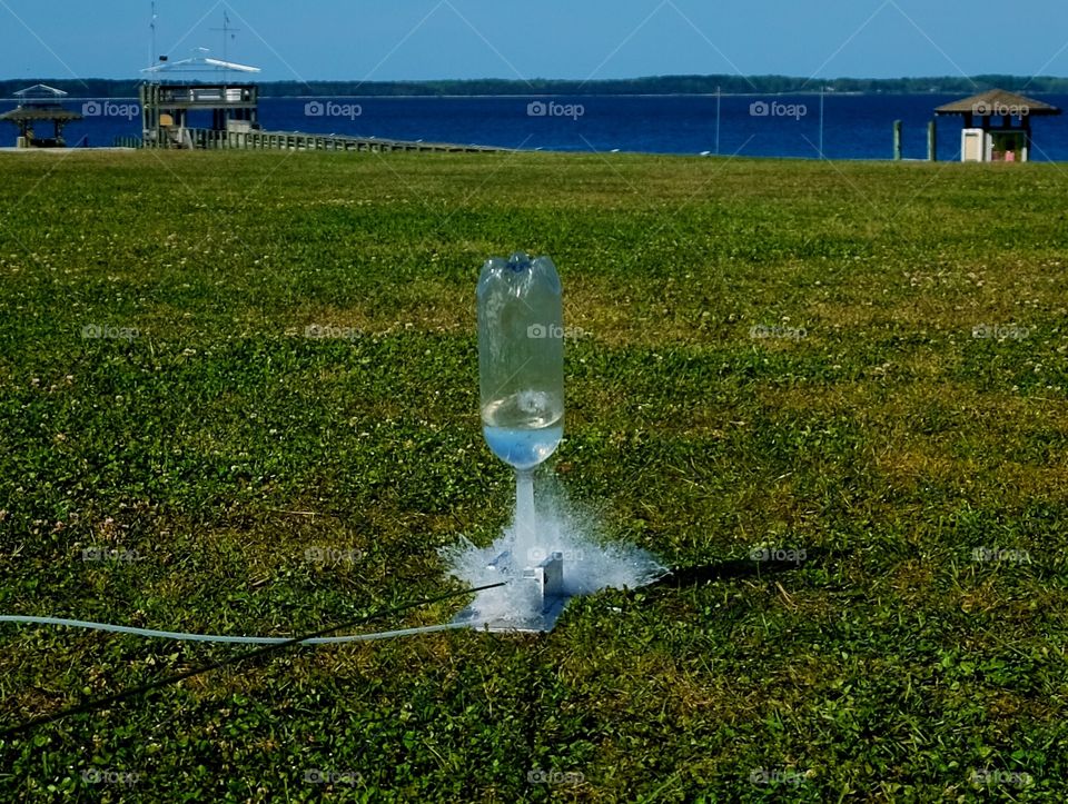 A water bottle rocket in mid launch as to blasts way up into the sky in Arapahoe North Carolina.