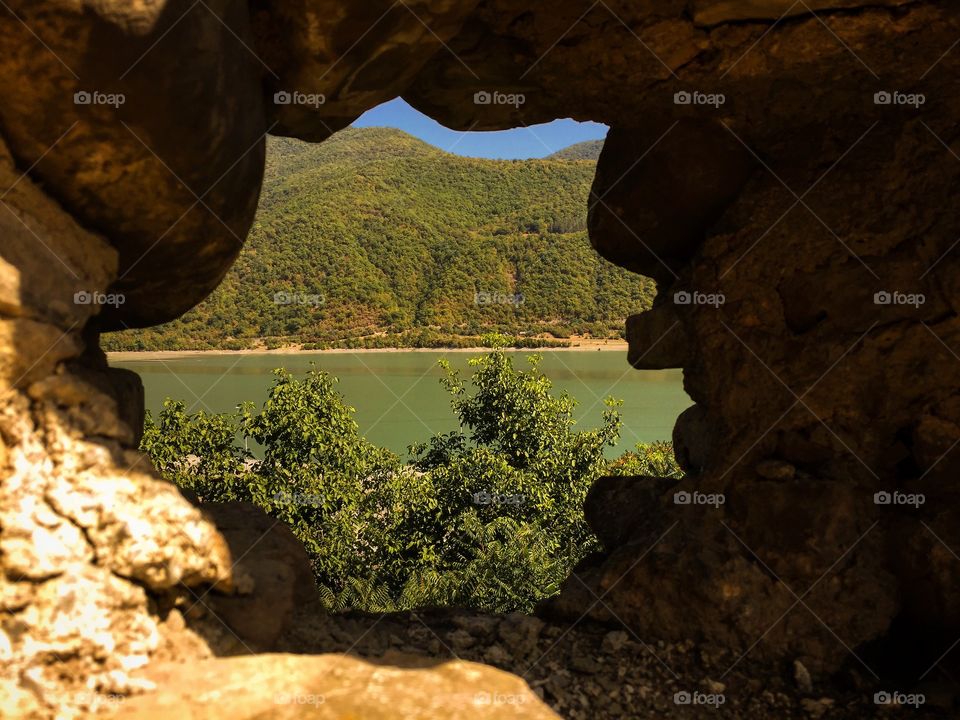 Beautiful view on the lake and mountains from the hole in the way