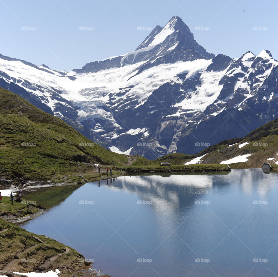 Bachalpsee reflecting mountains close to grindelwald first, switzerland.
