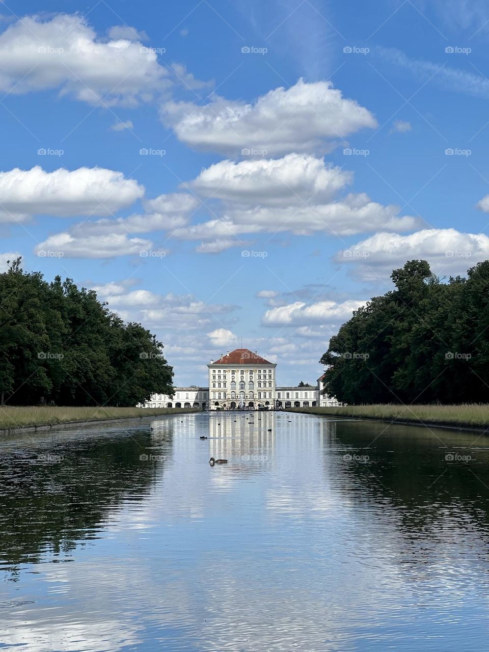 The elegant reflection of classic Nymphenburg castle in the small, but beautiful lake 