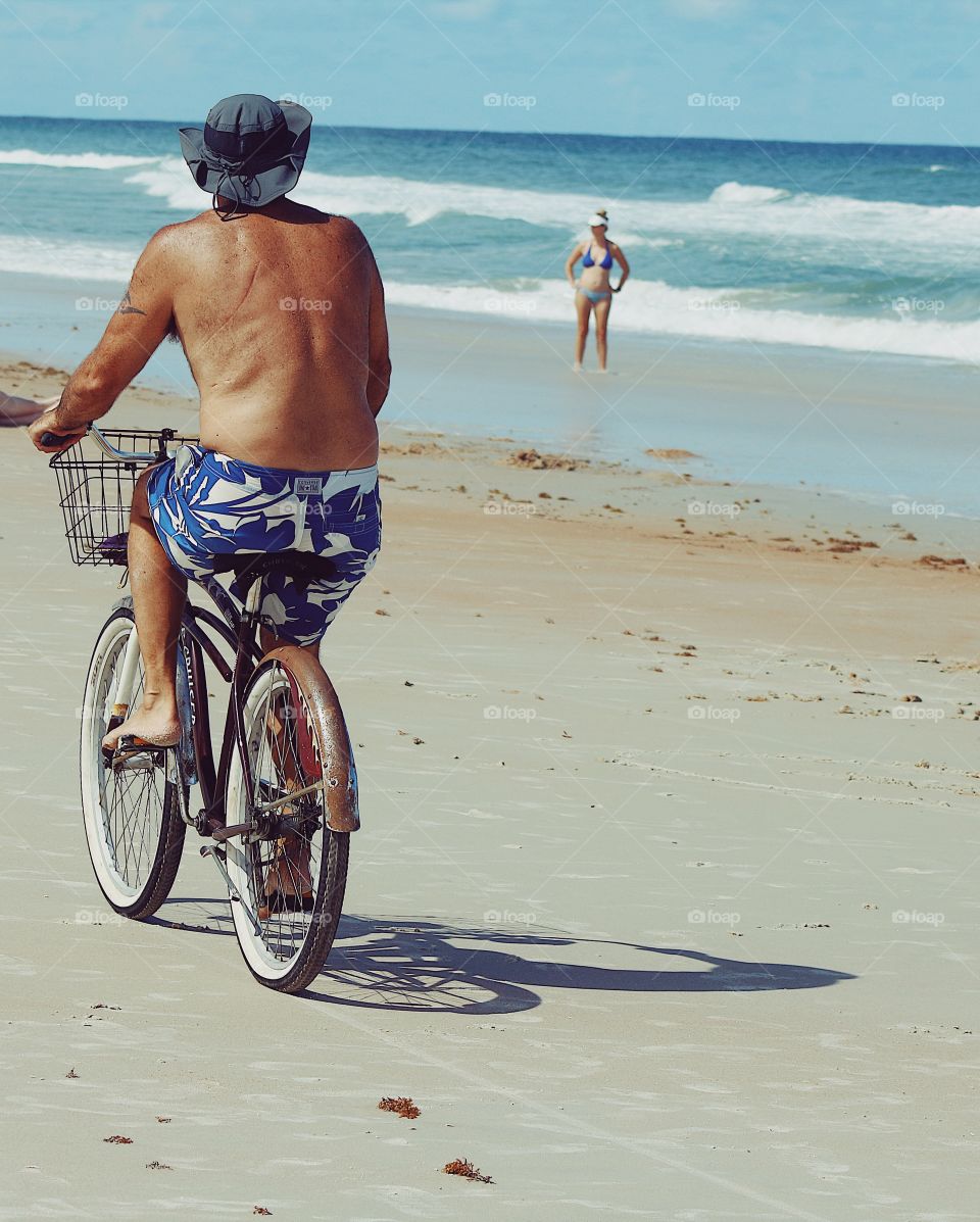 Beach lover cycling in summer 