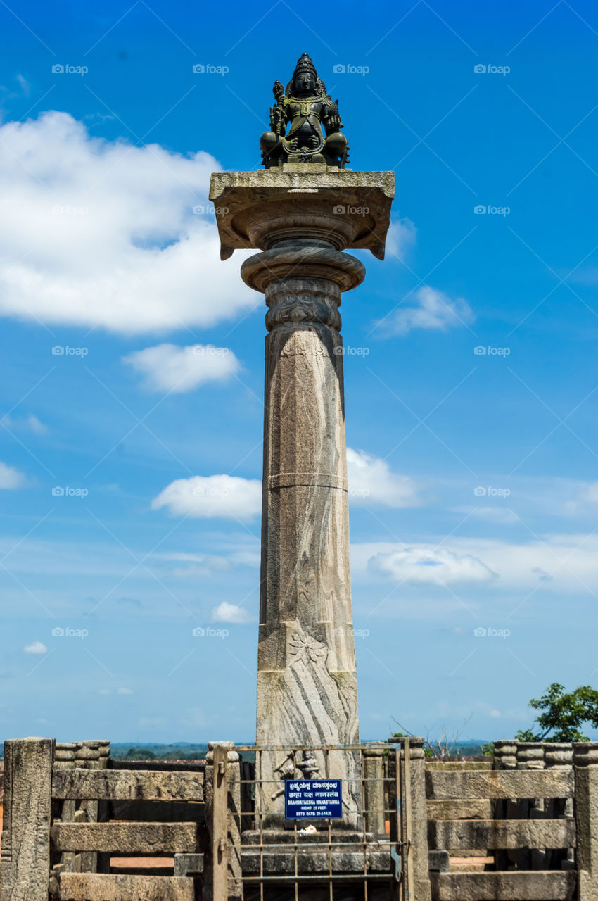 Brahma Yaksha Manastamba in front of Gomateshwara statue situated in Karkala, Karnataka, India. It was established in 1436 and it's height is 25 feet.