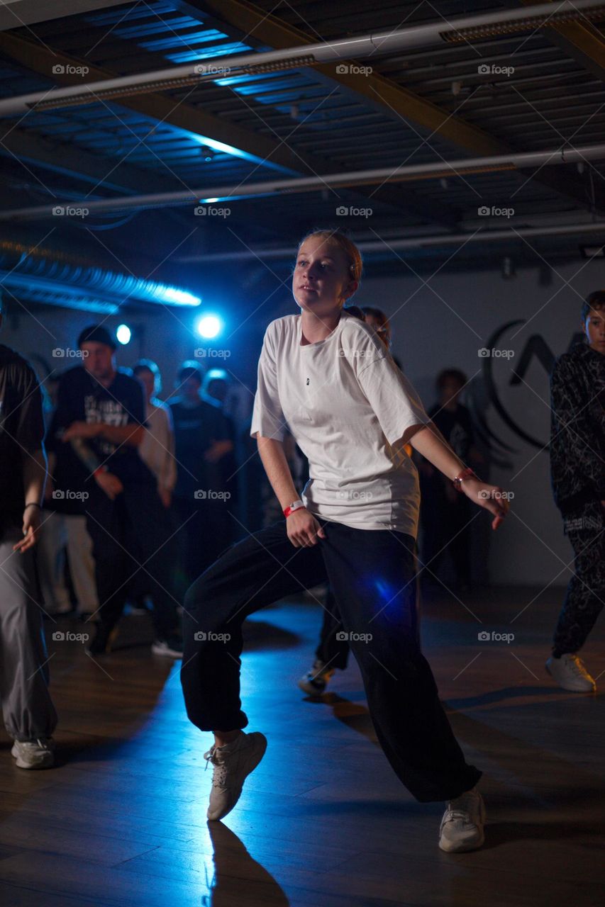 girl dancing in the dark of the hip-hop dance hall