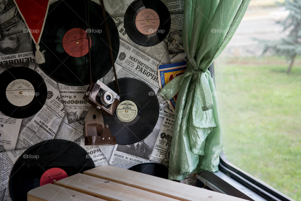 Old vinyls, newspapers and camera on the wall