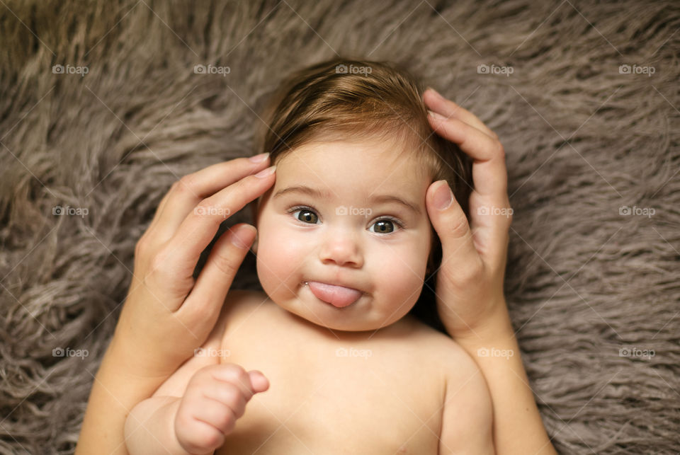 Baby lying on soft carpet