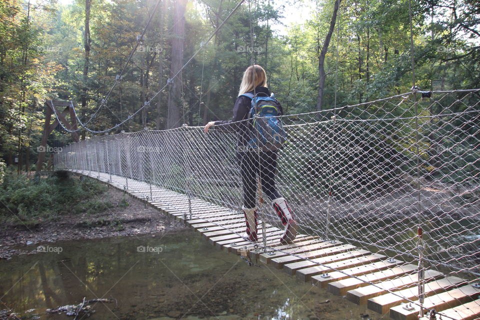 Woman hiking across bridge in Ohio, USA