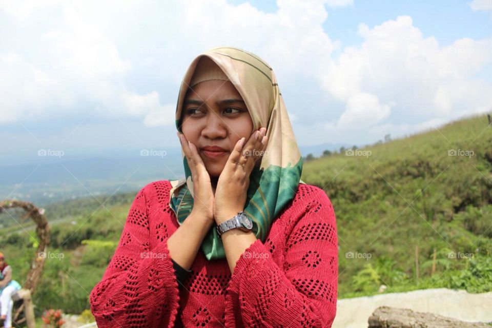 A young woman wearing a red dress