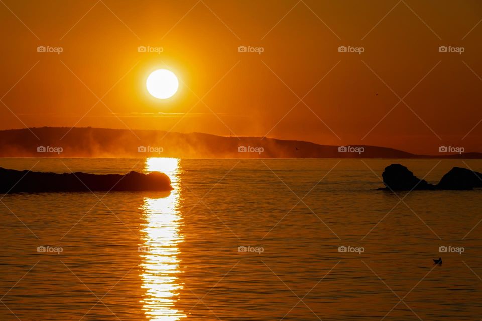 Warm sea and cold air cause sea evaporation best visible at sunset