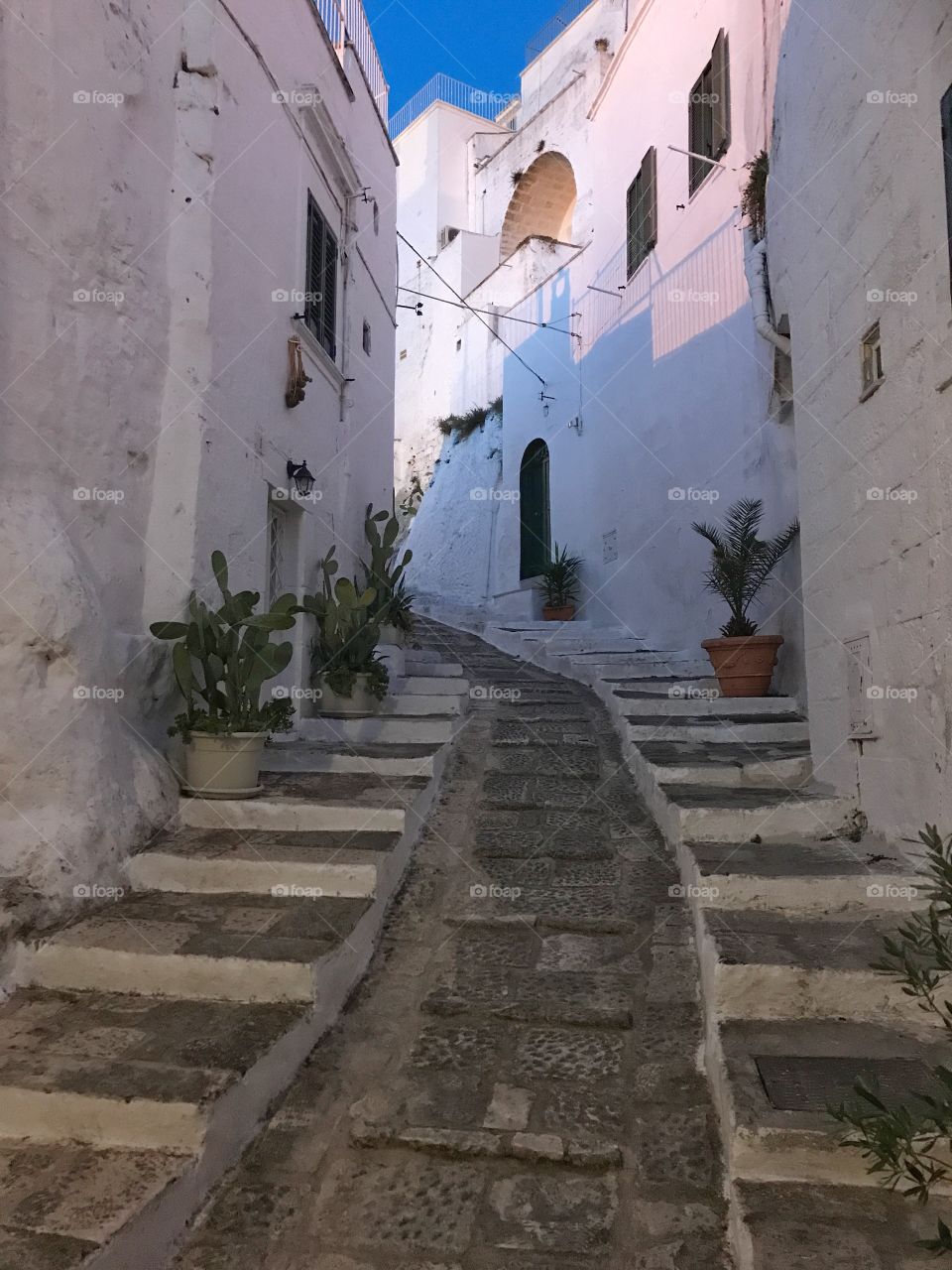 Typical narrow street in the white city of Ostuni, Puglia, Italy