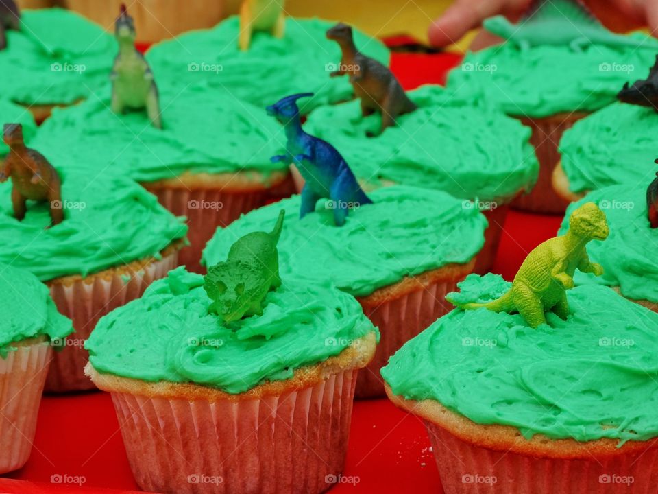 Birthday Cupcakes. Cupcakes Decorated With Green Frosting And Plastic Toy Dinosaurs
