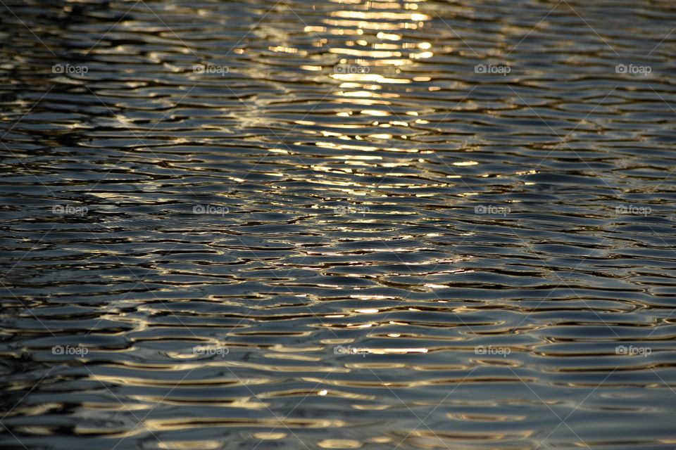 Evening sun on river abstract texture