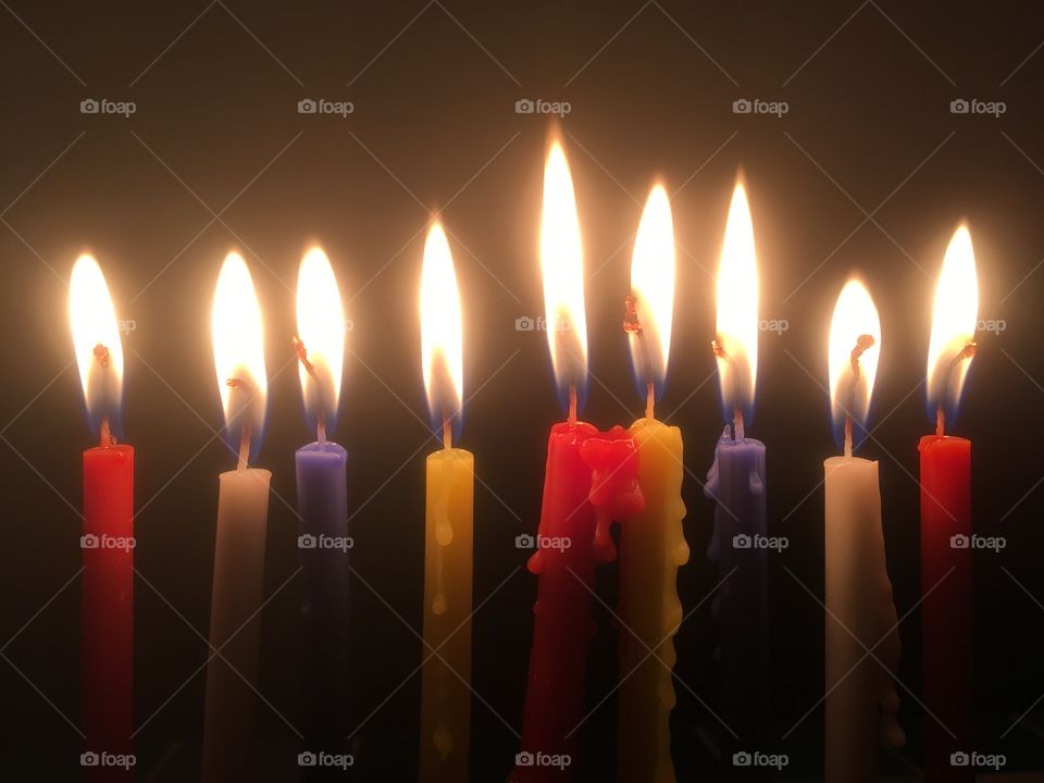 9 candles burning on the 8th day of the Jewish Chanukah festival, in Watford in Winter.