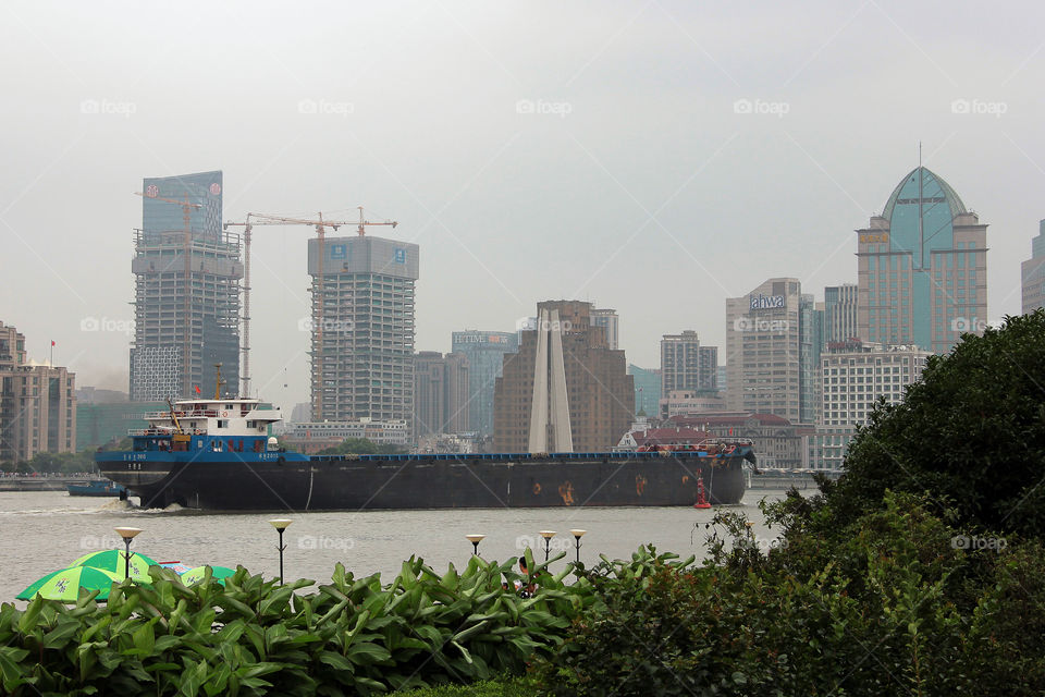 Freighter at the bundt china. A freighter sailing through shanghai, china.