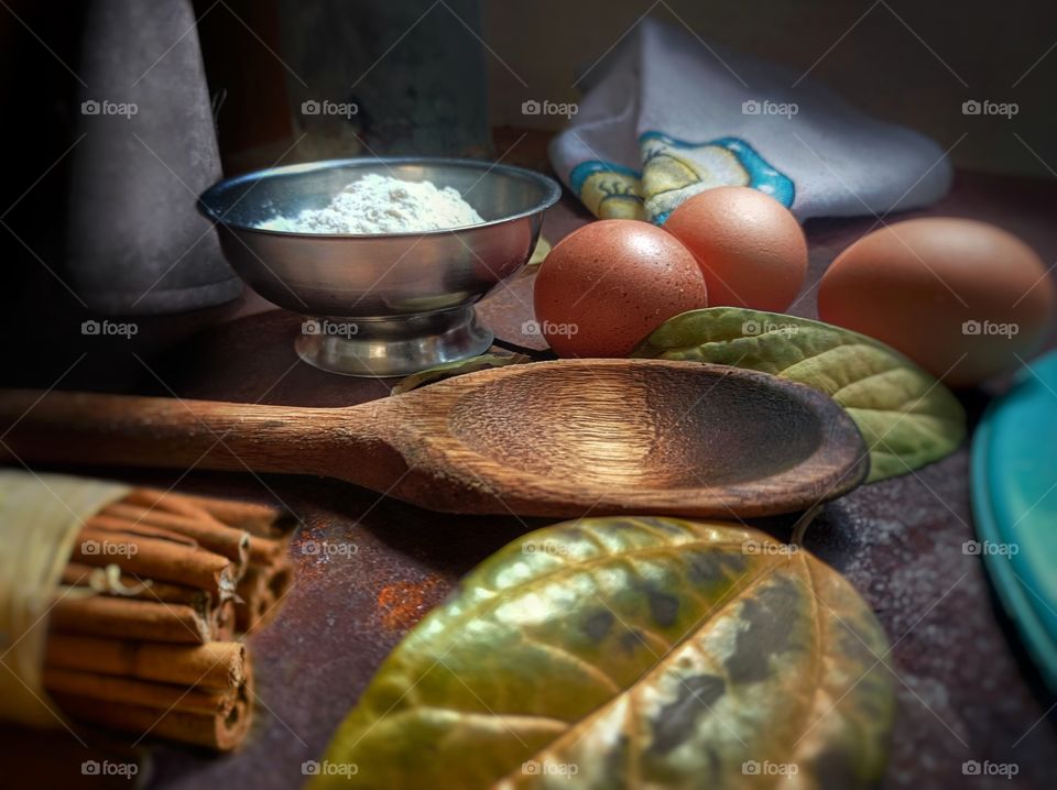 Ingredients and utensils for preparing cake and dry leaves