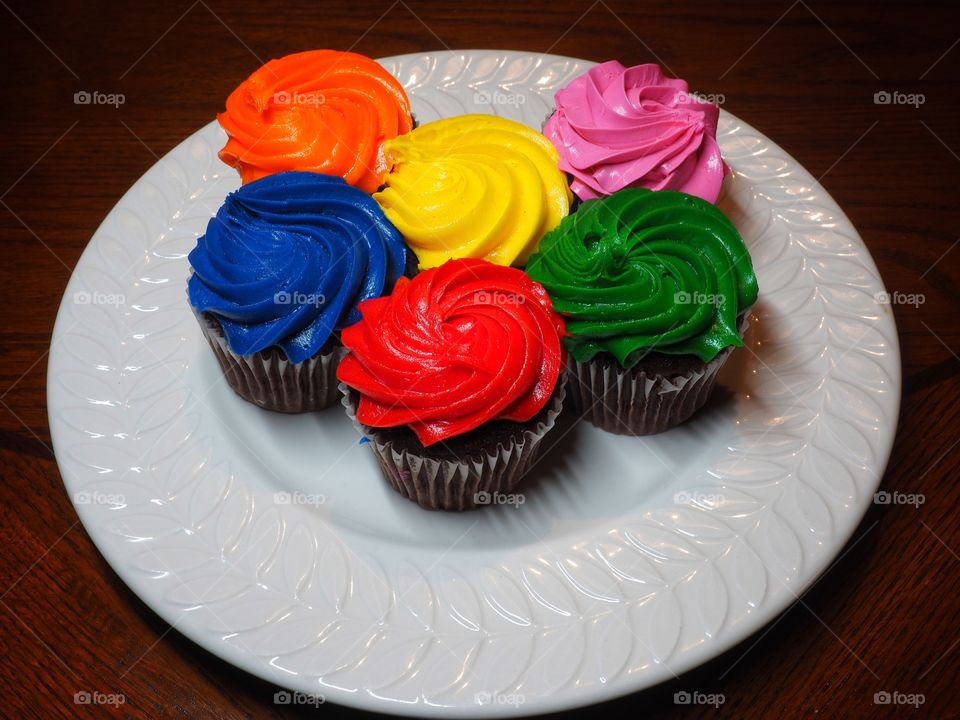 Delicious cupcakes on white plate