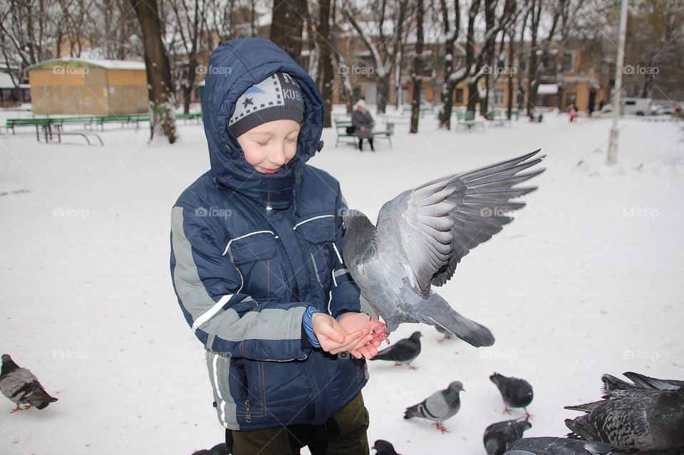 Boy with pigeon on his hand