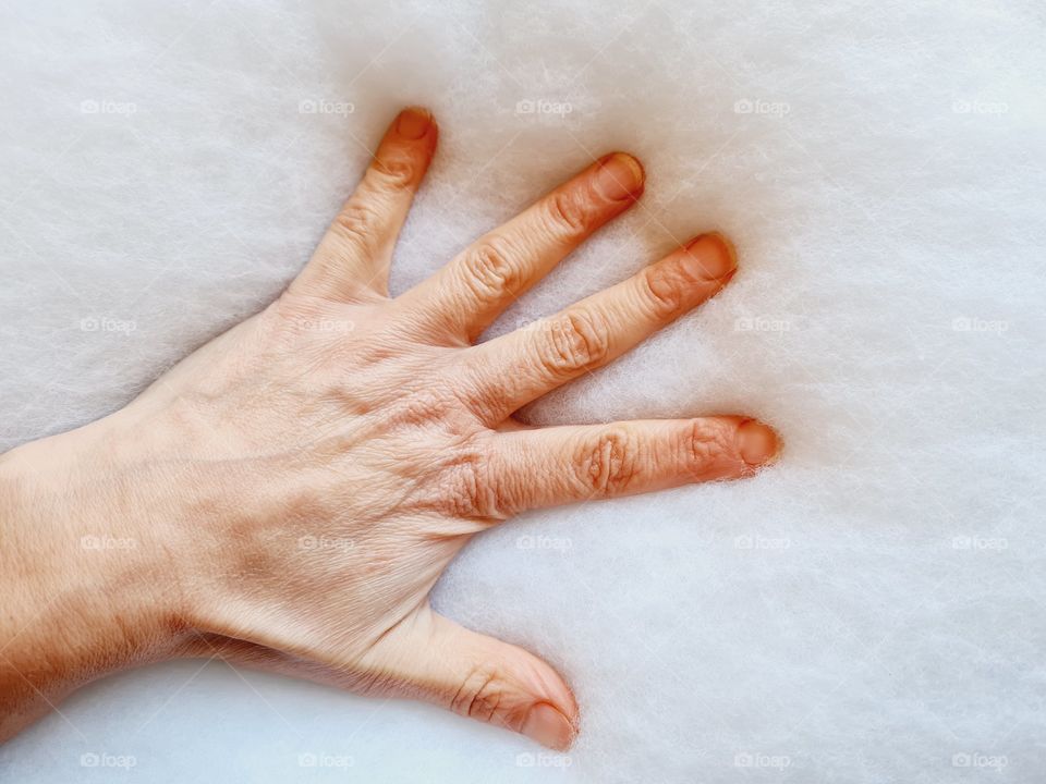 hand sinks on the stuffing of a pillow