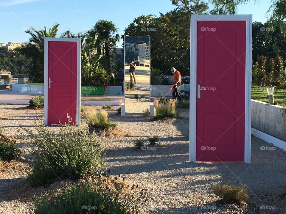 Pink doors decorating a city garden