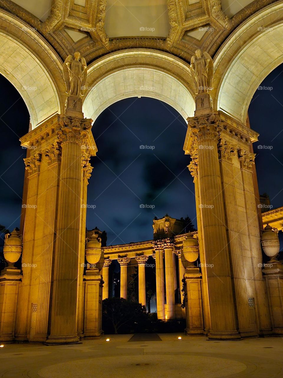 Nighttime at the Palace of Fine Arts in San Francisco California, this beautiful Beaux-Arts designed building by Bernard Maybeck for the 1915 Panama-Pacific International Exposition was meant to resemble Roman Ruins, looking through the rotunda
