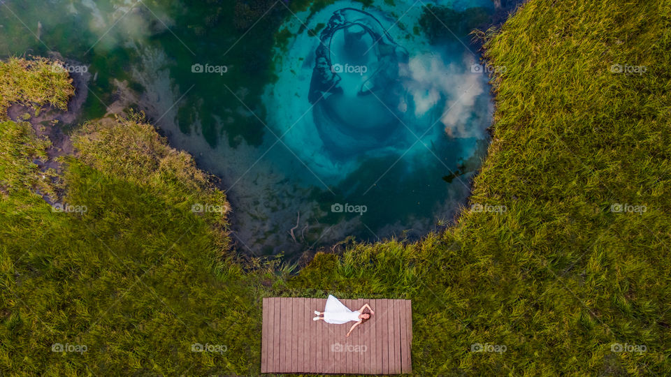 Girl laying near the lake