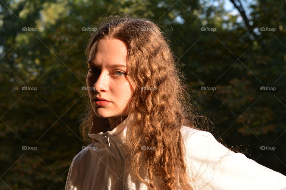 girl beautiful portrait in the sunlight outdoor green background summer time