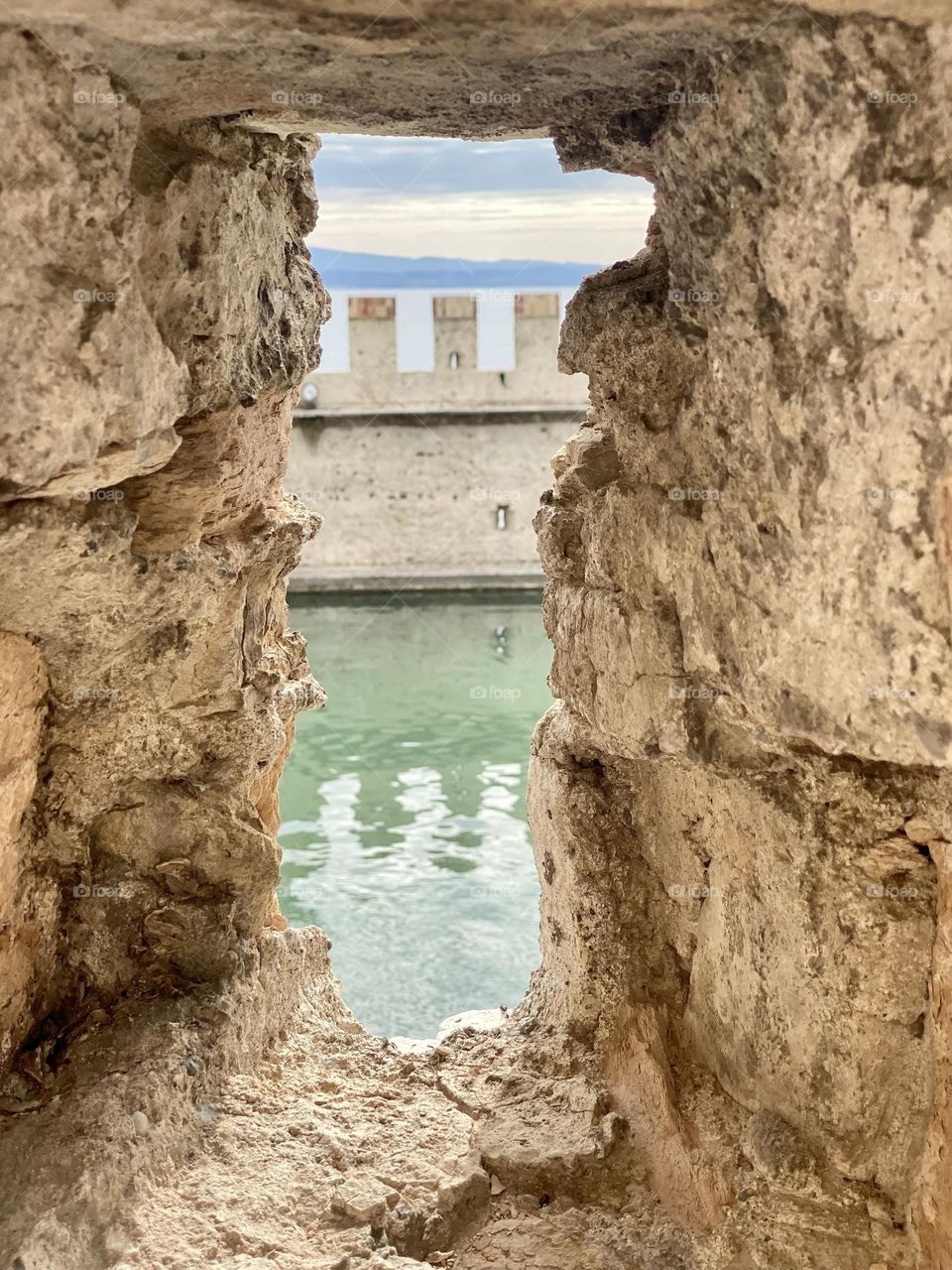 Window view of architectural design of castle and moat 