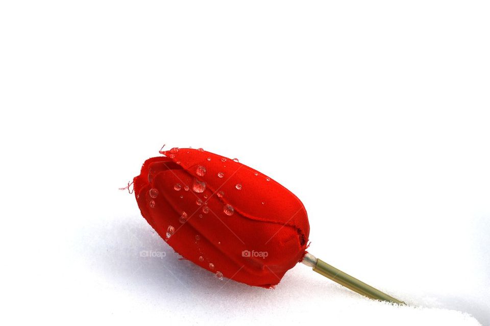 a fake flower in the snow