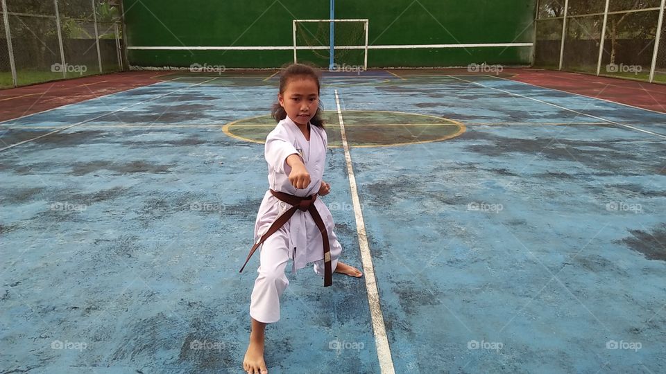 a young girl practicing karate
