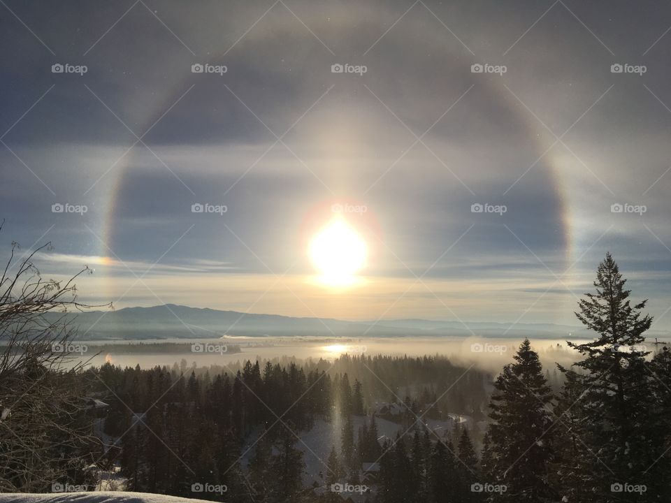 Rainbow ring around the sun at dawn.